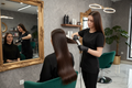Keratin smoothing treatment resulting in sleek shiny hair at a beauty salon